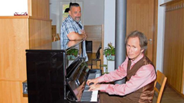 Wanja Belaga am Klavier in der Kulturscheune. Hinten sein Partner Martin Rathmann.
